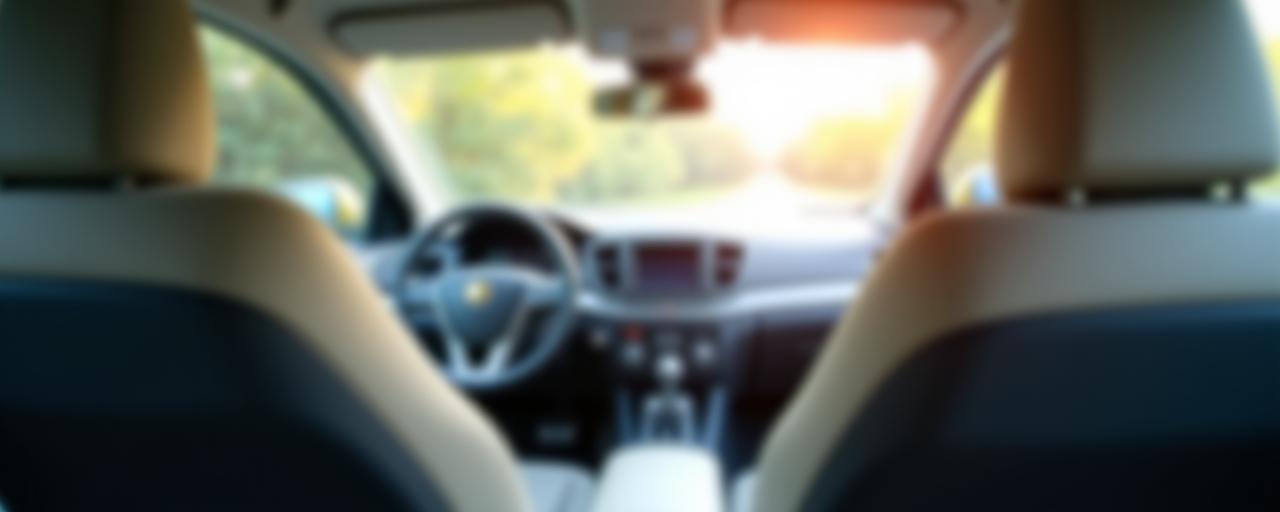 A softly blurred image of a safe and clean car interior.